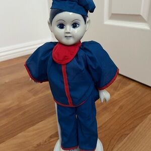 Blue and Red 12” Doll with Accessories. Includes stand.